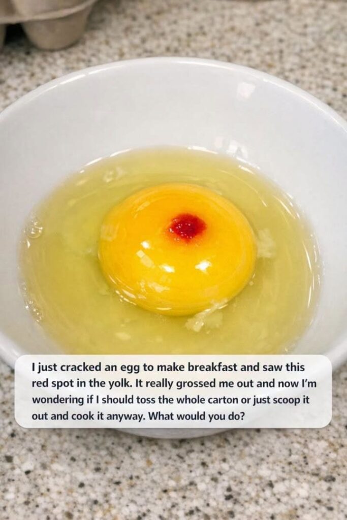 I just cracked an egg to make breakfast and saw this red spot in the yolk. It really grossed me out and now I’m wondering if I should toss the whole